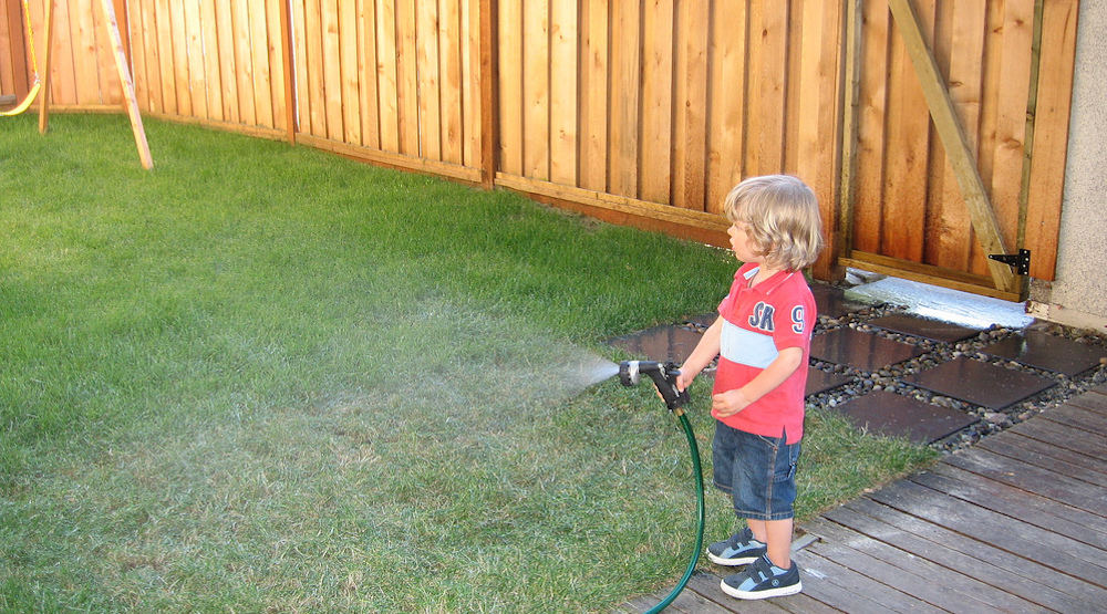 给草坪浇水的男孩
