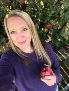 阿曼达·谢弗勒拿着自家后院树上的苹果